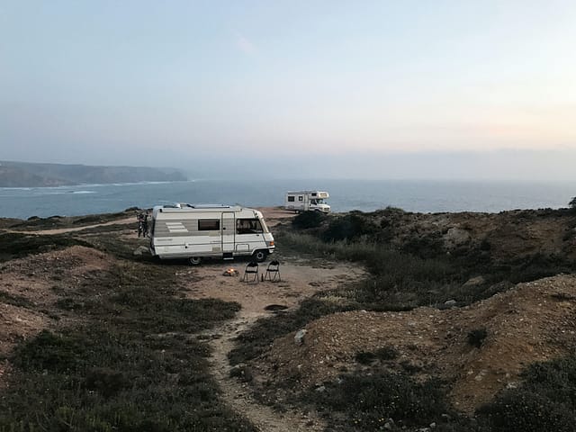 Two RVs camping next to the ocean